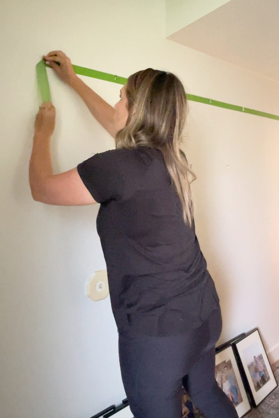 Taking tape off of wall when using it as a guide for hanging a gallery wall evenly.